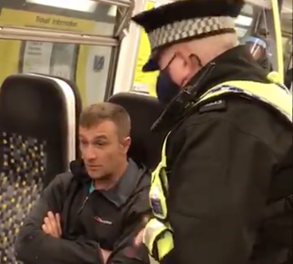 The officer and passenger exchanged words. (Video posted by @StopComplying)