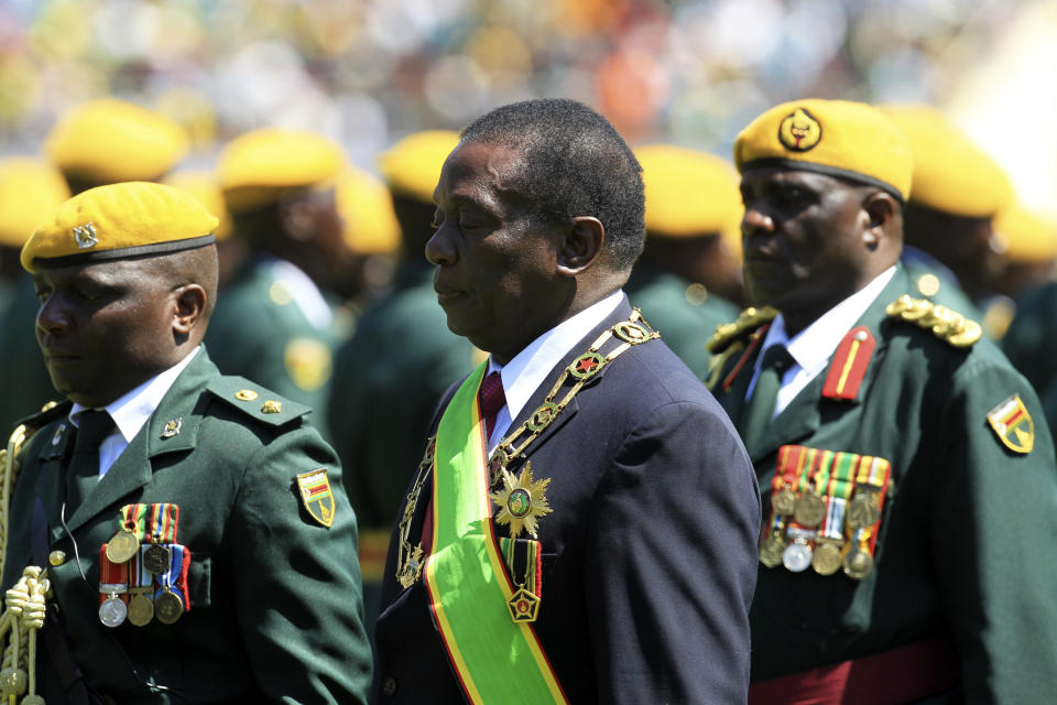 Zimbabwean President Emmerson Mnangagwa inspects the guard of honour during his inauguration ceremony at the National Sports Stadium in Harare, Sunday, Aug. 26, 2018. Zimbabwe on Sunday inaugurated a president for the second time in nine months as a country recently jubilant over the fall of longtime leader Robert Mugabe is now largely subdued by renewed harassment of the opposition and a bitterly disputed election. (AP Photo/Tsvangirayi Mukwazhi)