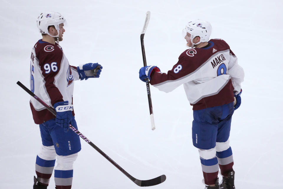 Colorado Avalanche's Cale Makar (8) celebrates his goal with Mikko Rantanen during the second period of the team's NHL hockey game against the Chicago Blackhawks on Thursday, Jan. 12, 2023, in Chicago. (AP Photo/Charles Rex Arbogast)