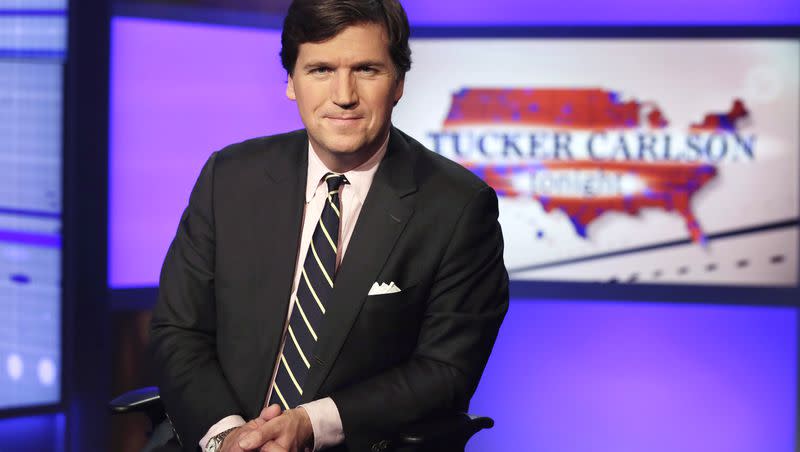 Tucker Carlson poses for photos in a Fox News Channel studio in New York on March 2, 2017. Carlson has spoken out against Sen. Mitt Romney and other Republican senators. 