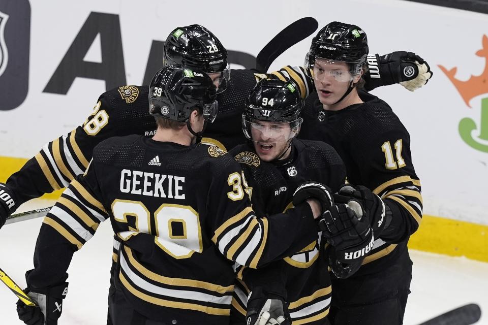 Boston Bruins' Jakub Lauko (94) celebrates after his goal with Morgan Geekie (39), Derek Forbort (28) and Trent Frederic (11) during the first period of an NHL hockey game against the Winnipeg Jets, Monday, Jan. 22, 2024, in Boston. (AP Photo/Michael Dwyer)