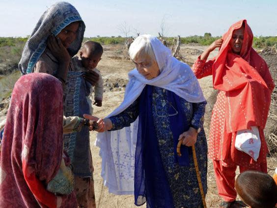 Ruth Pfau (C), head of a Pakistani charity fighting leprosy and blindness, meets people in flood-affected southern Pakistan in December 2010. She has died aged 87 (AFP/Getty Images)