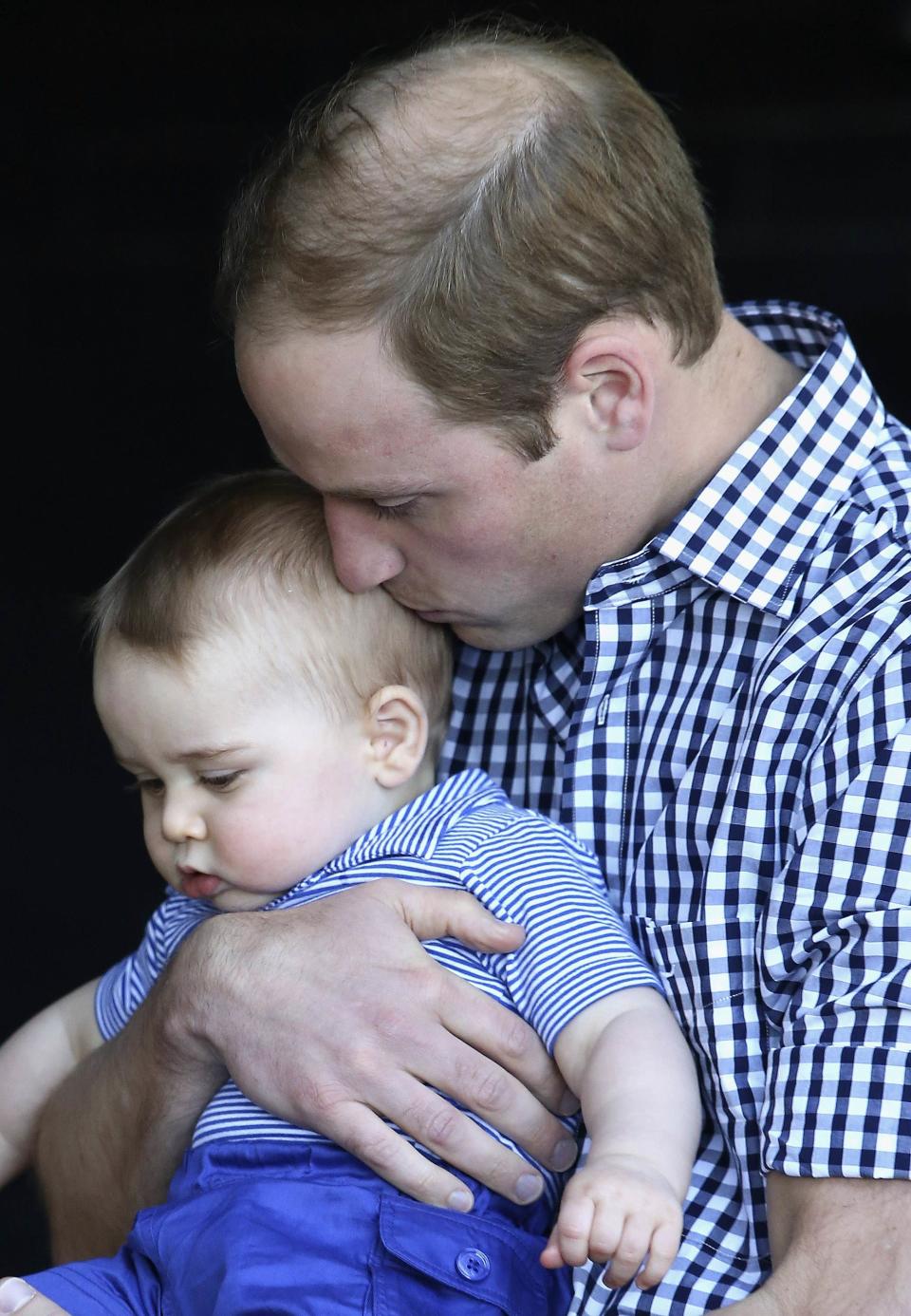 Britain's Prince William kisses his son Prince George as they meet a Bilby which has been named after the young prince at Taronga Zoo in Sydney April 20, 2014. Britain's Prince William and his wife Catherine, the Duchess of Cambridge, are on the second leg of a 19-day official visit to New Zealand and Australia with their son George. REUTERS/Chris Jackson/Pool (AUSTRALIA - Tags: ROYALS ENTERTAINMENT ANIMALS TPX IMAGES OF THE DAY PROFILE)