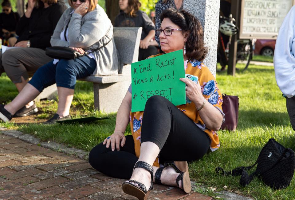 Hillary Farber holds a sign calling for an end to racism during the vigil for George Floyd in front of the Parkway United Methodist Church in Milton, Wednesday, May 25, 2022.