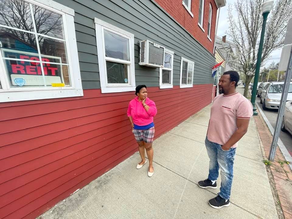 Fifi's Grocery owners Lisia "Fifi" and Frandy Jean-Baptiste stand outside the former sports bar next to their store. Acquiring the space would increase the size of the store from 400 to 2,000 square feet.