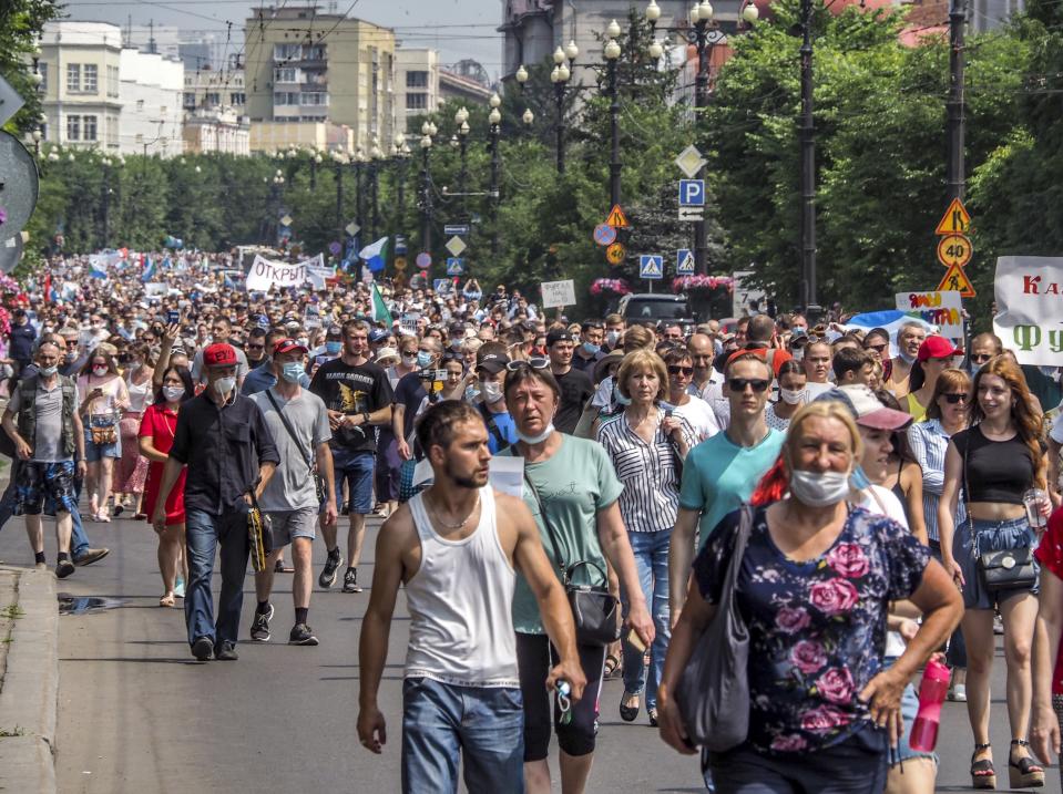 People march during a protest in support of Sergei Furgal, the governor of the Khabarovsk region, in Khabarovsk, 6100 kilometers (3800 miles) east of Moscow, Russia, Saturday, July 18, 2020. Tens of thousands of people in the Russian Far East city of Khabarovsk took to the streets on Saturday, protesting the arrest of the region's governor on charges of involvement in multiple murders. Local media estimated the rally in the city attracted from 15,000 to 50,000 people. (AP Photo/Igor Volkov)