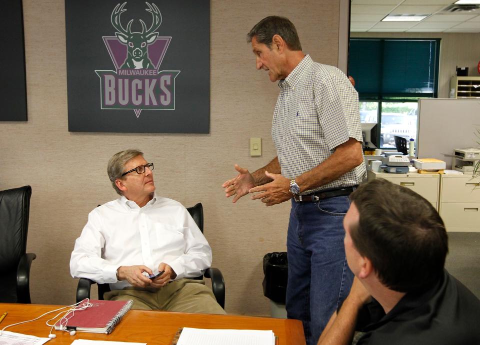 Former Bucks legend Jon McGlocklin talks with former general manager John Hammond before the start of the NBA draft in 2013.