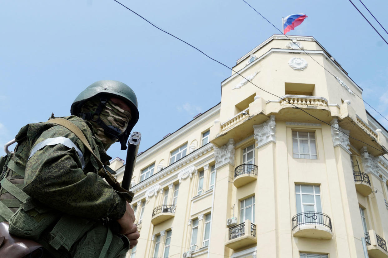 A member of the Wagner group stands guard outside the headquarters of the Russian Southern Military District in the city of Rostov-on-Don