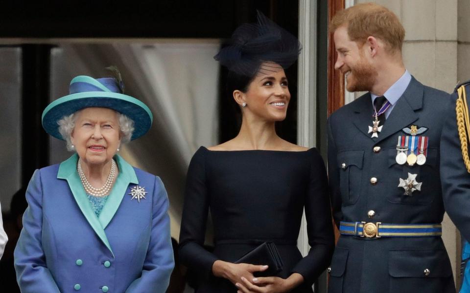 Britain's Queen Elizabeth II, and Meghan the Duchess of Sussex and Prince Harry  - Matt Dunham/AP
