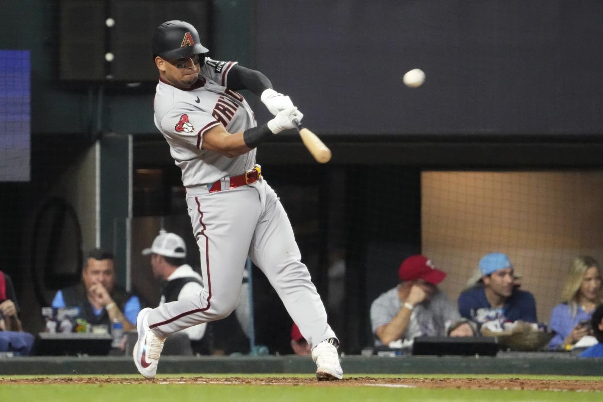 Arizona Diamondbacks catcher Gabriel Moreno (14) hits a home run against the Texas Rangers during the fourth inning in game two of the 2023 World Series at Globe Life Field on Oct. 28, 2023, in Arlington, Texas.