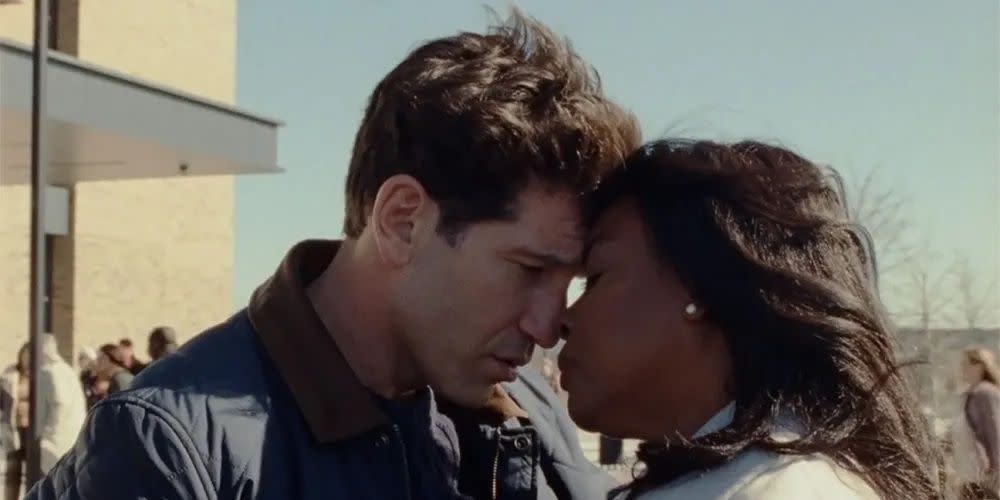 origin, jon bernthal and aunjanue ellis, a white man and black woman, outdoors with their foreheads touching