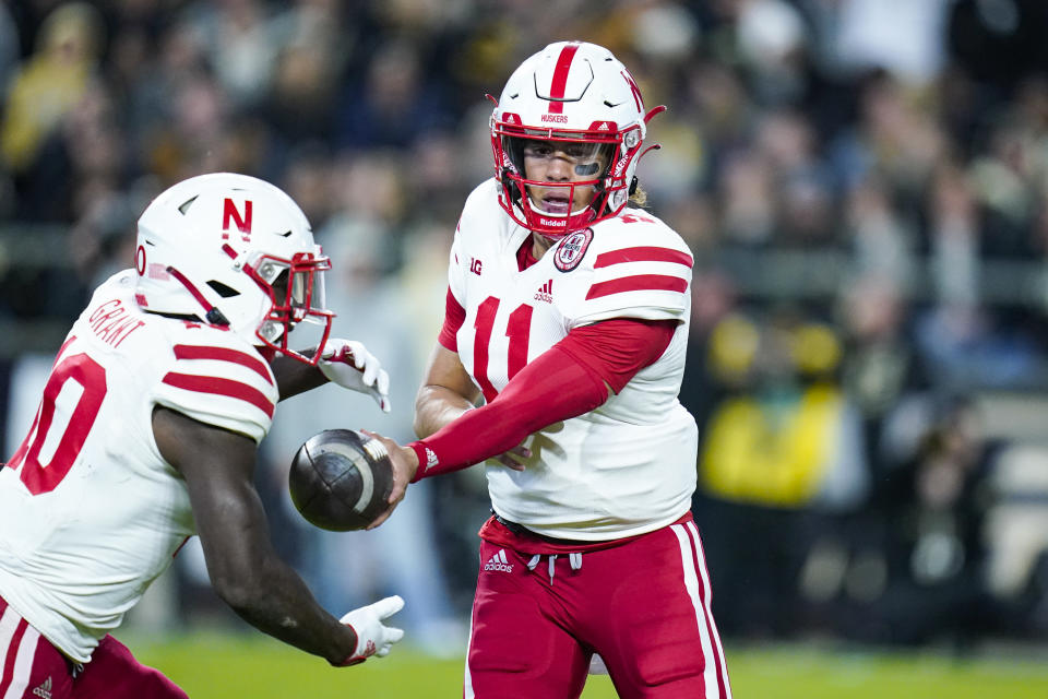 Nebraska quarterback Casey Thompson (11) hands off to running back Anthony Grant during the first half of an NCAA college football game in West Lafayette, Ind., Saturday, Oct. 15, 2022. (AP Photo/Michael Conroy)