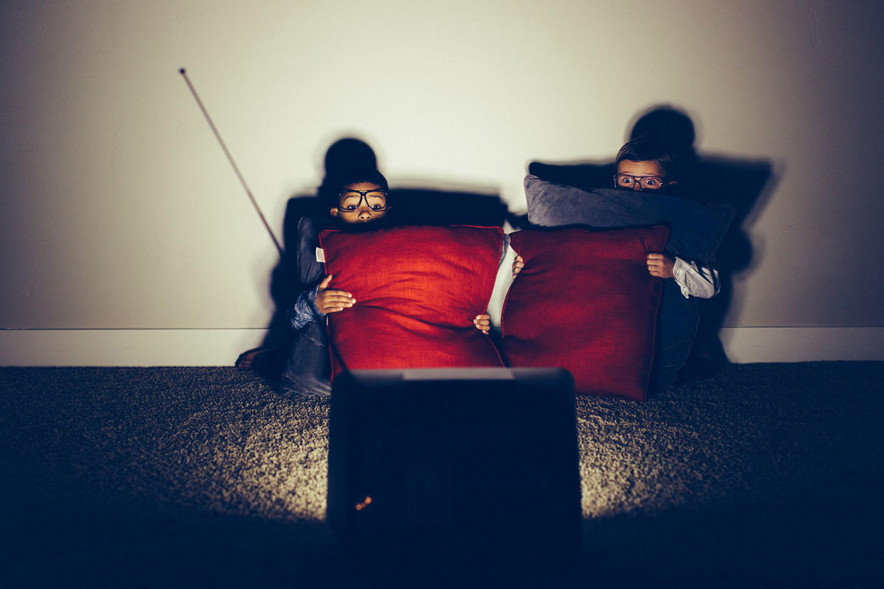 Two kids watching a horror movie Getty Images/RichVintage