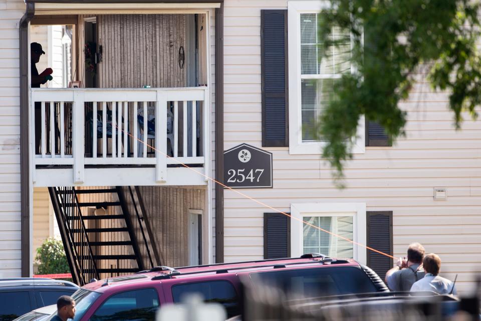 Tennessee Bureau of Investigation agents and Memphis Police Department appear to use a piece of string to determine the angle a MPD officer was firing from at the scene of “a possible officer-involved shooting" after a man TBI identified as Eugene McNeal was found dead following a standoff with officers during a barricade situation in Raleigh on Sunday, August 20, 2023.