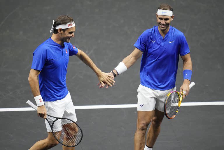 Team Europe's Roger Federer, left, and Rafael Nadal react during their Laver Cup doubles match against Team World's Jack Sock and Frances Tiafoe at the O2 arena in London, Friday, Sept. 23, 2022. (AP Photo/Kin Cheung)