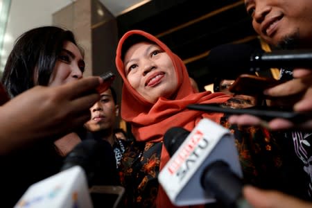 Baiq Nuril Maknun reacts to journalists as she arrives at Law and Human Rights ministry office in Jakarta