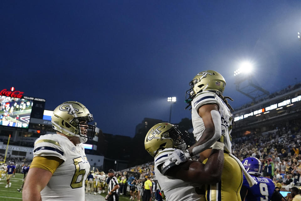 Georgia Tech wide receiver Nate McCollum, right, celebrates with offensive lineman Jordan Williams, center, after scoring a touchdown in the first half during an NCAA college football game against Western Carolina, Saturday, Sept. 10, 2022, in Atlanta. (AP Photo/Brynn Anderson)