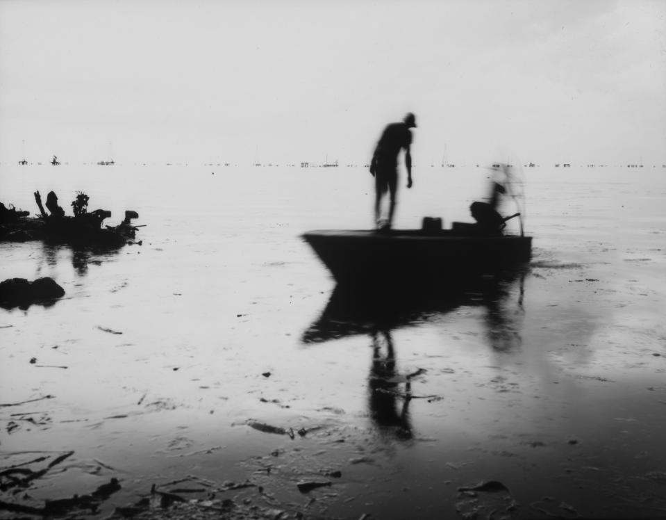 Fishermen get ready to start harvesting crabs in the oil-contaminated Lake Maracaibo near Cabimas, Venezuela, July 5, 2019. (AP Photo/Rodrigo Abd)