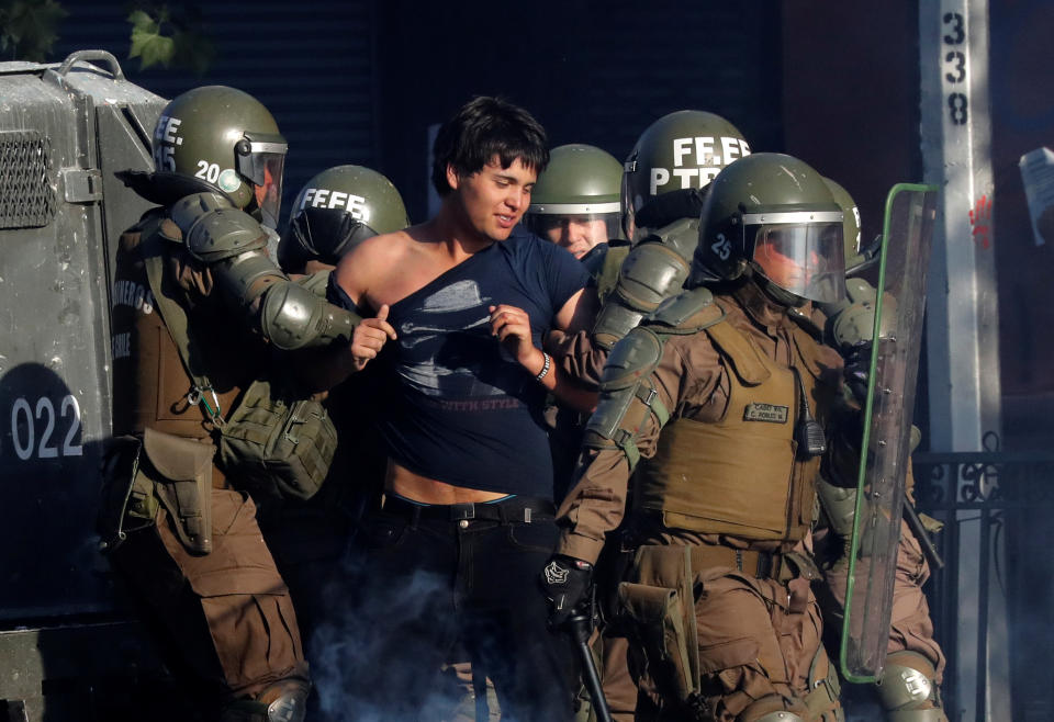 Members of security forces detain a demonstrator during an anti-government protests in Santiago, Chile on Oct. 28, 2019. (Photo: Henry Romero/Reuters)