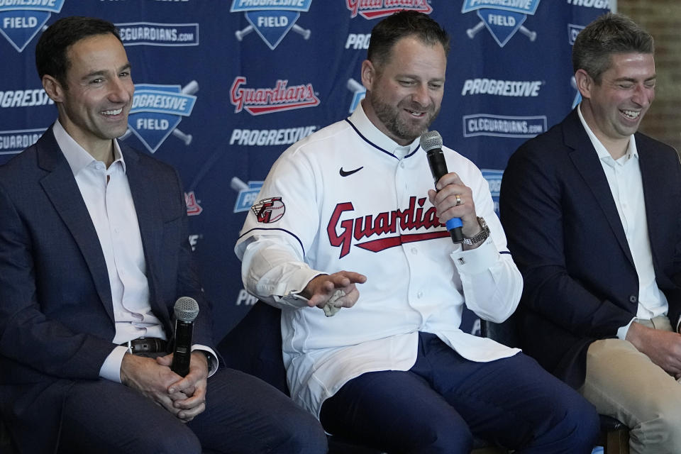 Stephen Vogt, center, speaks during a news conference introducing him as the manager of the Cleveland Guardians at a news conference Friday, Nov. 10, 2023, in Cleveland. At left is Chris Antonetti, president of baseball operations. At right is Mike Chernoff, general manager. (AP Photo/Sue Ogrocki)