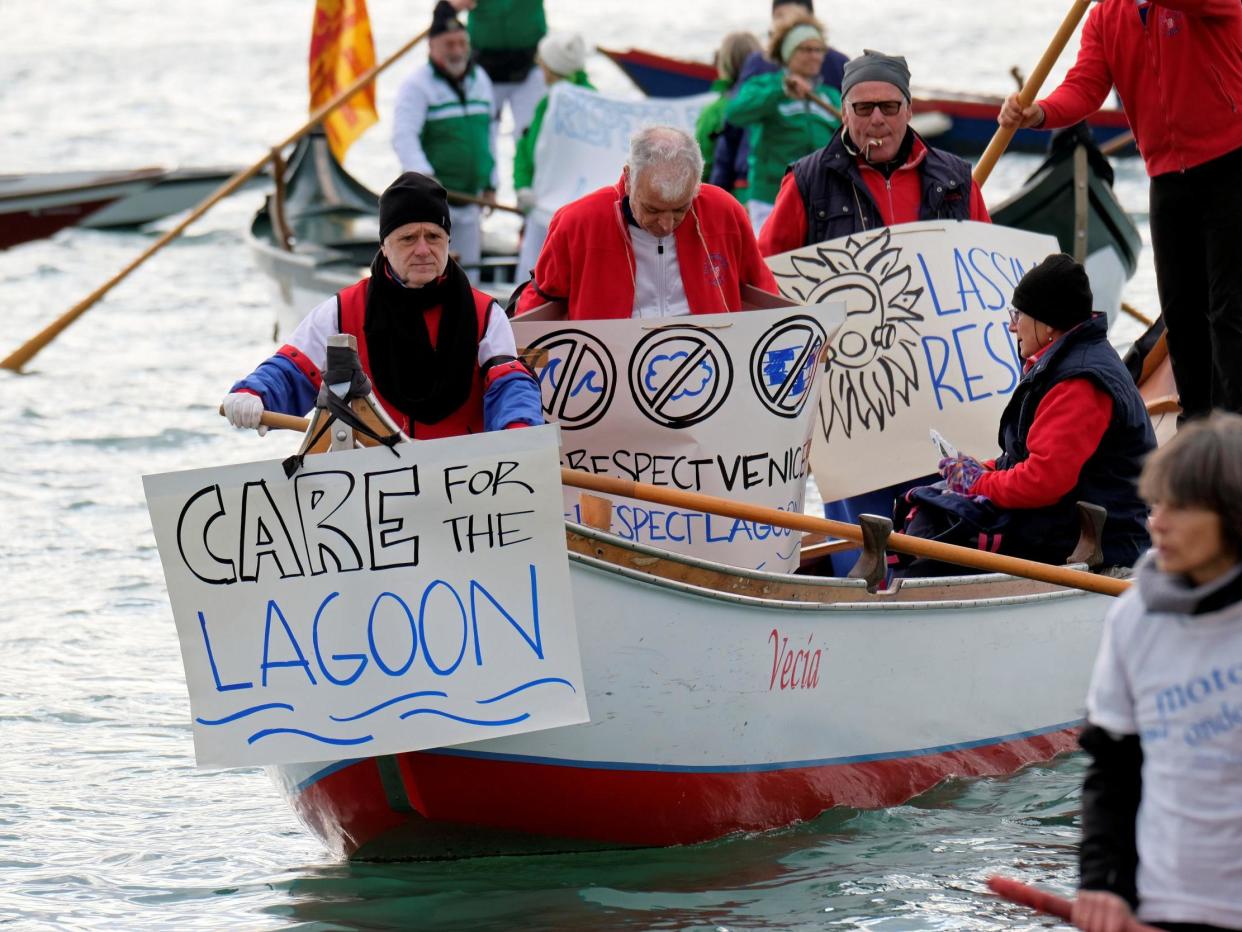 Venetian protesters hold placards during the demonstration against the damage caused by big ships: REUTERS