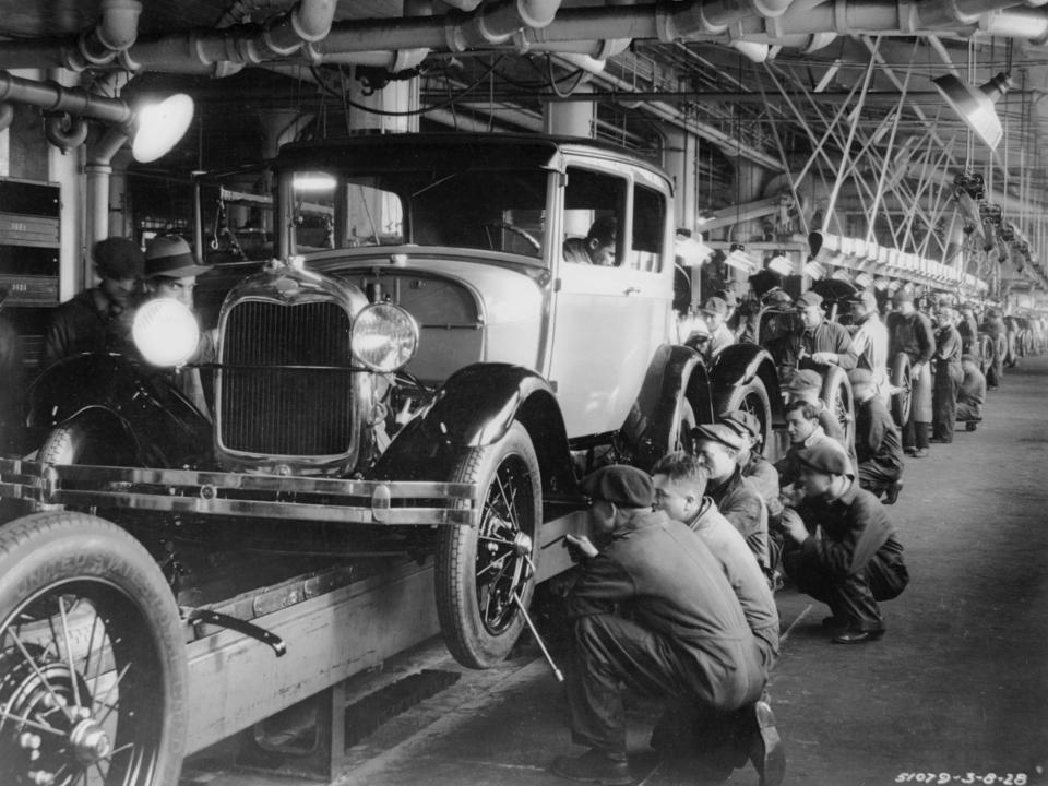 1927: The production line at a Ford motor factory in Michigan, USA.