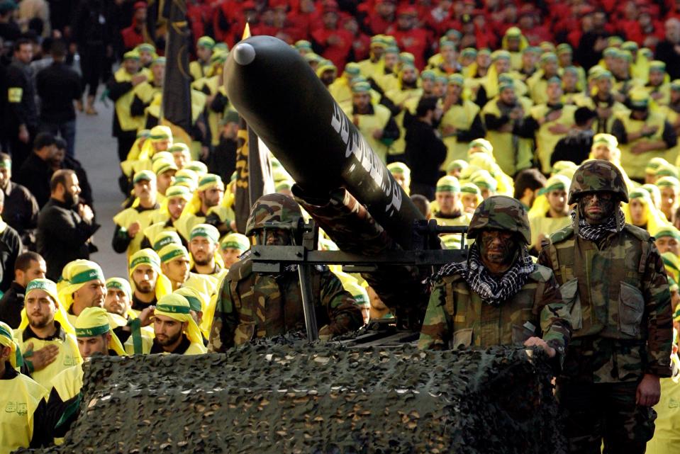 Hezbollah militants ride on a vehicle carrying a Fajr-5 rocket during the annual parade in the southern town of Nabatiyeh on November 28, 2012. <em>MAHMOUD ZAYYAT/AFP via Getty Images</em>