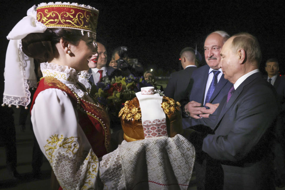 Russian President Vladimir Putin, right, and Belarusian President Alexander Lukashenko, second right, attend a welcome ceremony upon his arrival at an international airport in Minsk, Belarus, Thursday, May 23, 2024. (Mikhail Metzel, Sputnik, Kremlin Pool Photo via AP)