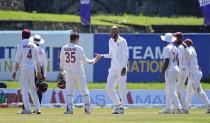 West Indies bowler Roston Chase, centre, is congratulated by his team mates for taking the wicket of Sri Lankan batsman Pathum Nissanka during the fourth day of their second test cricket match in Galle, Sri Lanka, Thursday, Dec. 2, 2021. (AP Photo/Eranga Jayawardena)