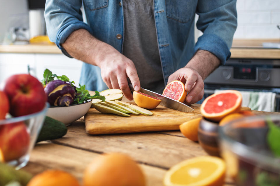 Cooking healthy and tasty food concept. Male hands preparing vegetarian food at home kitchen