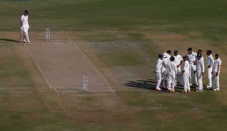 Cricket - India v England - Third Test cricket match - Punjab Cricket Association Stadium, Mohali, India - 26/11/16. Indian players celebrate the dismissal of Joe Root as England's Alastair Cook (L) looks on. REUTERS/Adnan Abidi