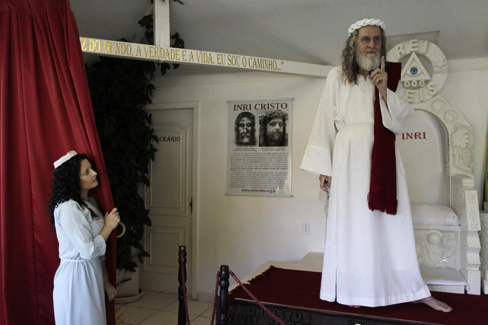 Inri Cristo (R), a Brazilian religious leader who claims to be Jesus Christ reincarnated, gestures on stage as a supporter looks on in Brasilia February 12, 2013. Cristo, who was born Alvaro Theiss in Indaial, Santa Catarina state, Brazil on March 22, 1948, said he is happy that Pope Benedict XVI resigned because he is the 'real son of god.' REUTERS/Ueslei Marcelino (BRAZIL - Tags: RELIGION) - RTR3DPH1