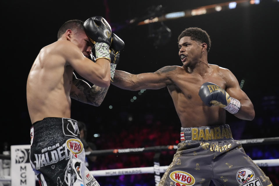 Shakur Stevenson, right, throws a punch at Oscar Valdez during a WBC-WBO junior lightweight title boxing bout Saturday, April 30, 2022, in Las Vegas. (AP Photo/John Locher)