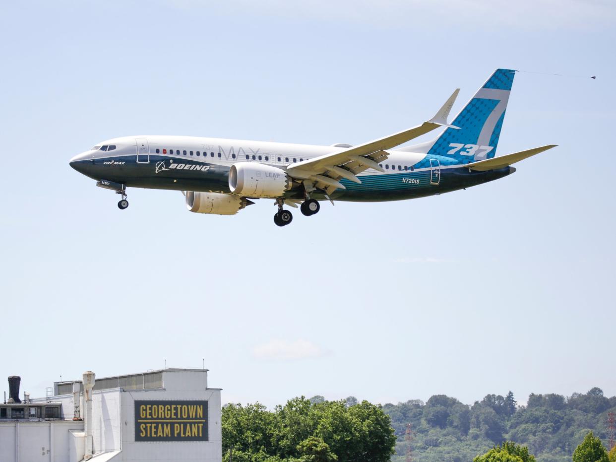 <p>A Boeing 737 MAX jet lands following an FAA test flight </p> (AFP via Getty Images)