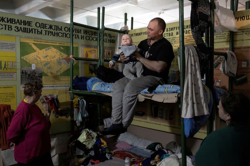 FILE PHOTO: A man holds his baby inside Azot chemical plant in Sievierodonetsk, Ukraine,