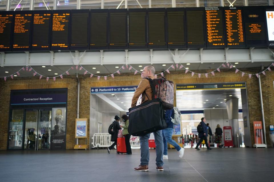 Travellers at King’s Cross station on Friday  (PA)