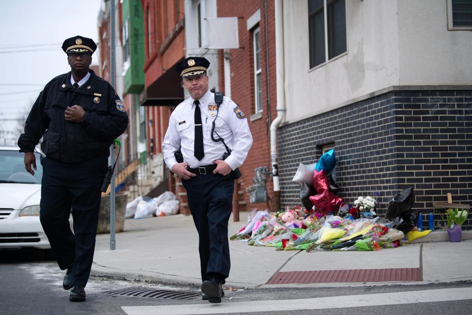 Captain Michael Goodson, left, and inspector Ray Evers leave the memorial made for officer Chris Fitzgerald, who was killed while responding to an incident, on the intersection of West Montgomery Avenue and North Bouvier Street in North Philadelphia on Monday, Feb. 20, 2023.