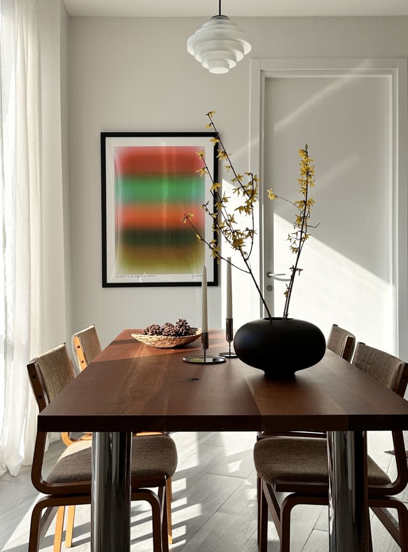 A decorated dining room table in a white room.