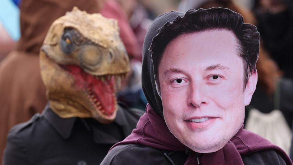 An activist wears an Elon Musk mask at a protest in Berlin in April 2023.