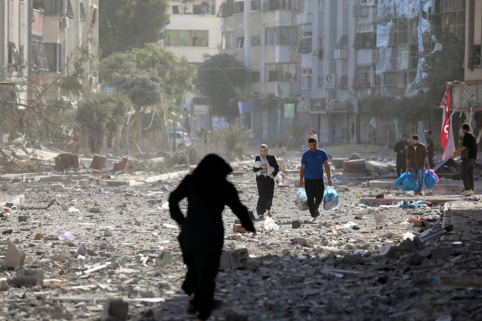 Palestinians leave their homes following Israeli bombardment on Gaza City, Monday, Oct. 30, 2023.