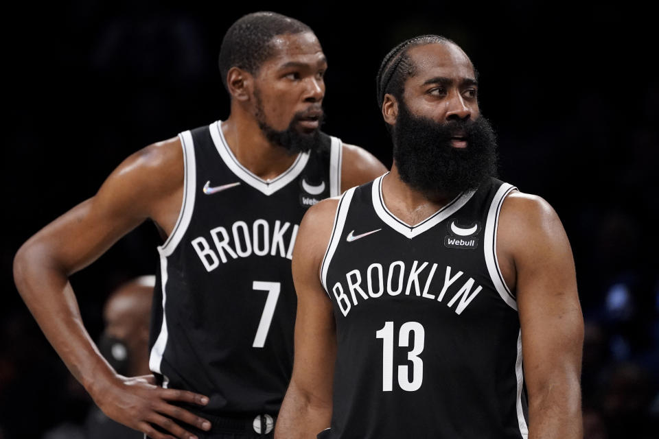 Brooklyn Nets guard James Harden (13) reacts to a referee's call alongside forward Kevin Durant (7) during the first half of an NBA basketball game against the Miami Heat, Wednesday, Oct. 27, 2021, in New York. (AP Photo/John Minchillo)