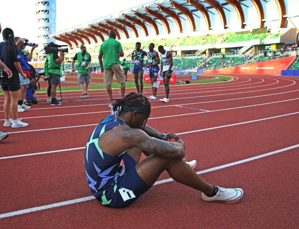 Former Duck Cravon Gillespie sits on the track while the winners of the men's 100 meter dash are interviewed on TV during the U.S. Olympic Track & Field Trials at Hayward Field in Eugene.