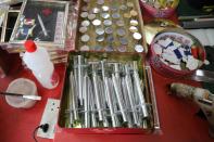 Paper syringes and vaccine vials are pictured at a prayer paraphernalia shop in Johor Bahru