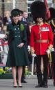 <p>In 2017, the Duchess turned to one of the late Princess Diana’s favourite designers for her coat: Catherine Walker. The dark green number, adorned with two rows of gold buttons, was decorated with her Irish Guards brooch and boasted a black trim. <em>[Photo: Getty]</em> </p>