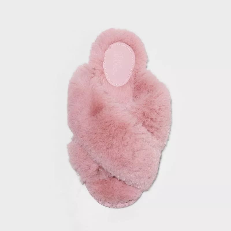 Fluffy pink slipper with a crisscross design