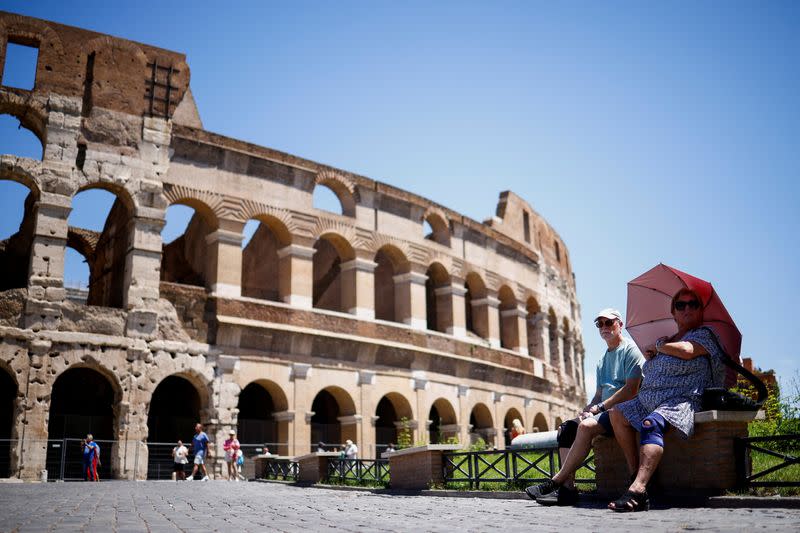 FILE PHOTO: Tourists struggle during hot weather in Rome