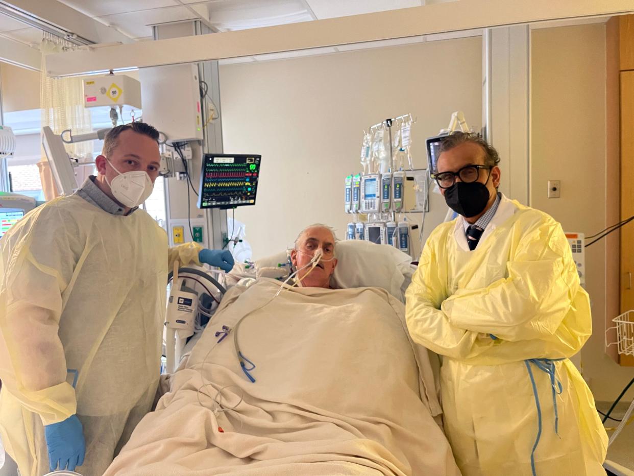 David Bennett Jr., left, Dave Bennett Sr., center, and Dr. Muhammad Mohiuddin, director of the Program in Cardiac Xenotransplantation at the University of Maryland School of Medicine, are photographed on Jan. 12, 2022. Dave Bennett, 57, of Maryland, agreed to be the first to risk experimental surgery, the first time a gene-edited pig has been used as an organ donor.