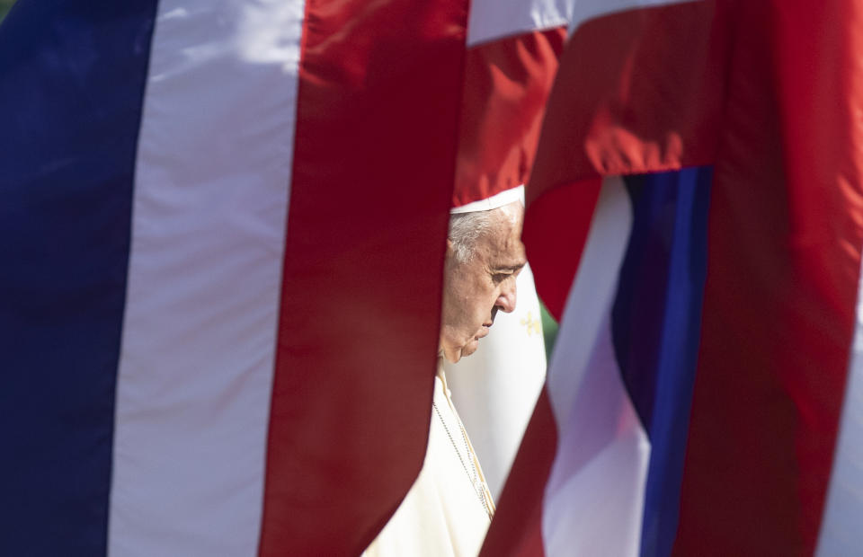 Pope Francis listens to national anthems during a welcoming ceremony at the government house in Bangkok, Thailand, Thursday, Nov. 21, 2019. Pope Francis is on a four-day visit to Thailand. (AP Photo/Sakchai Lalit)