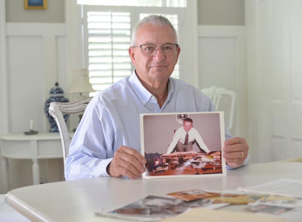 David Nadolski is a retired FBI agent who has written a book, "The Con and the FBI Agent: An Unlikely Alliance." He was photographed at his home in Orleans holding a photo of himself taken in February 1999 of the weapons taken from an arrest that were going to be used in an armored truck robbery