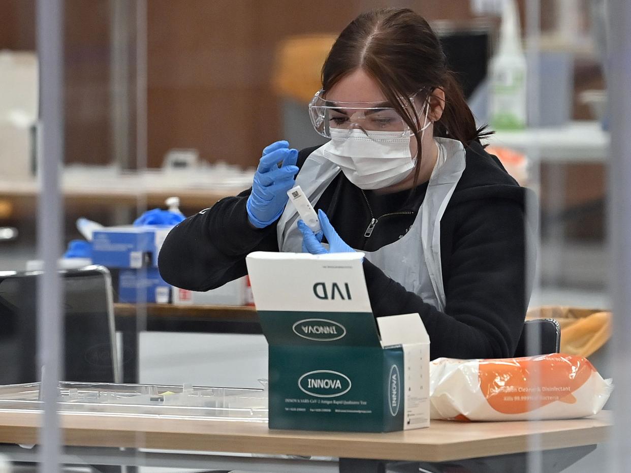 A worker processes an Innova lateral flow test taken by a Hull University student in April (AFP/Getty)